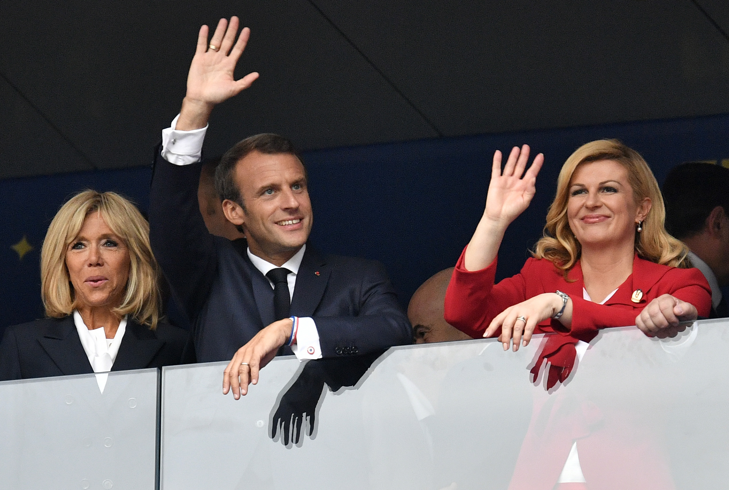 French President Emmanuel Macron, his wife Brigitte, left, and Croatian President Kolinda Grabar-Kitarovic wave prior to the final match between France and Croatia at the 2018 soccer World Cup in the Luzhniki Stadium in Moscow - AP